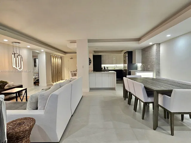 a large kitchen with a table and chairs