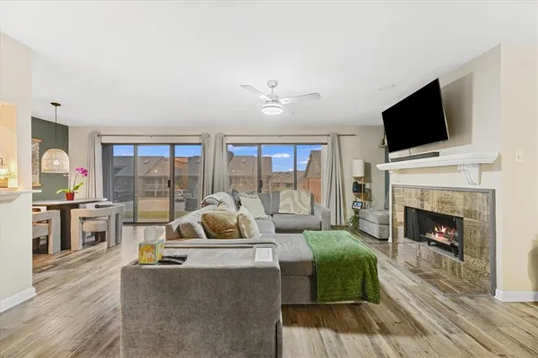 a living room with furniture fireplace and flat screen tv