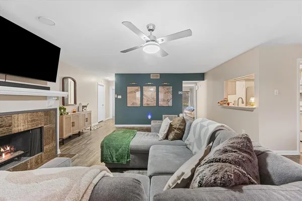 a living room with furniture a fireplace and a flat screen tv