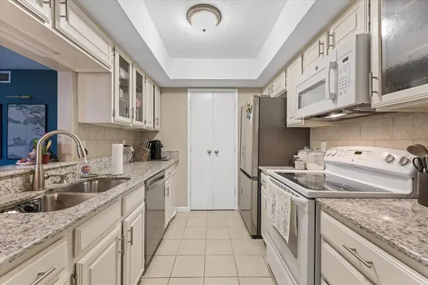 a kitchen that has a sink and a stove