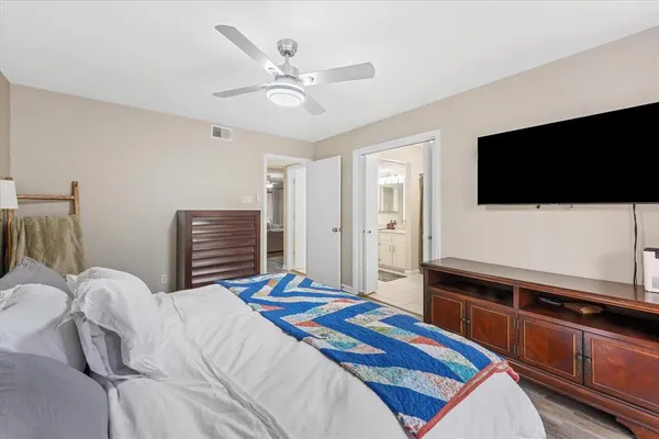 a bedroom with a bed and a flat screen tv