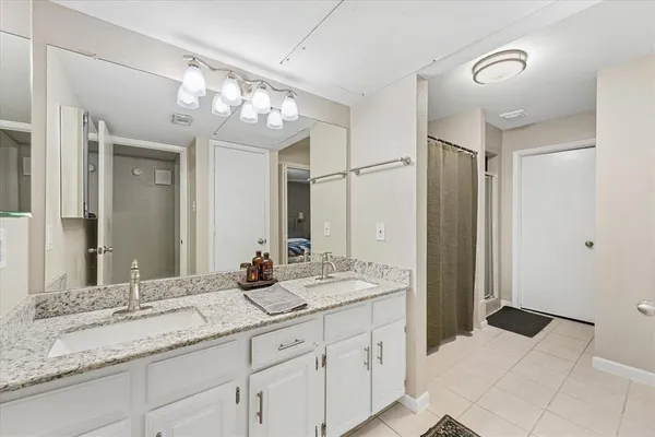 a bathroom with a granite countertop sink mirror and double