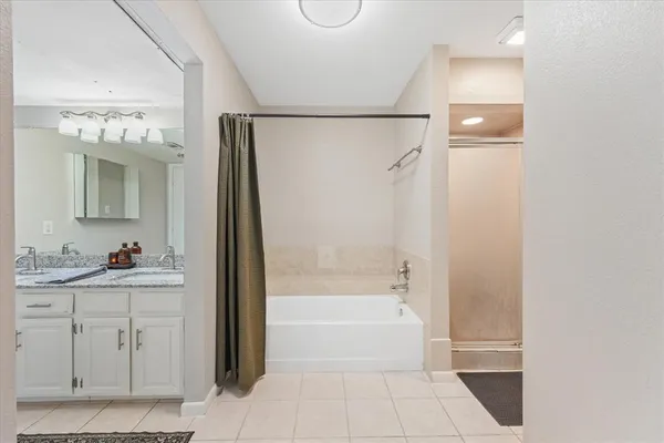 a bathroom with a bathtub a toilet and a shower