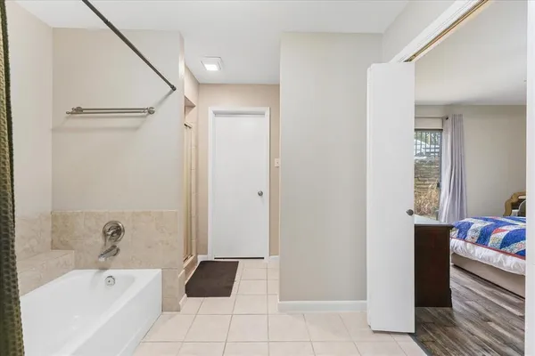 a bathroom with a bathtub and a shower