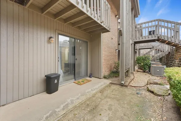 a view of a patio with table and chairs and potted plants