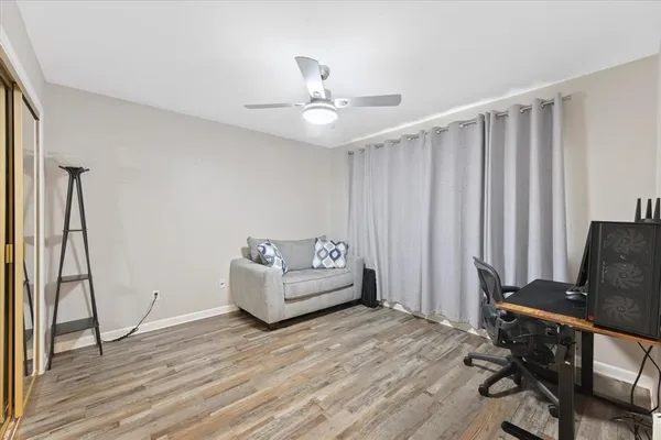 a bedroom with furniture and wooden floor
