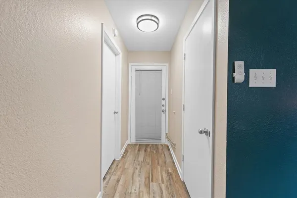 a view of a hallway with wooden floor