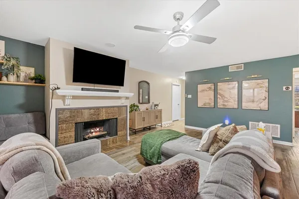 a living room with furniture fireplace and flat screen tv