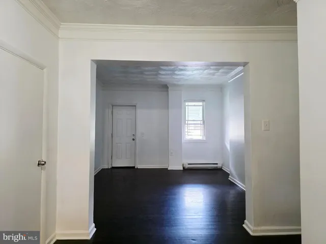 a view of a livingroom with wooden floor and a window