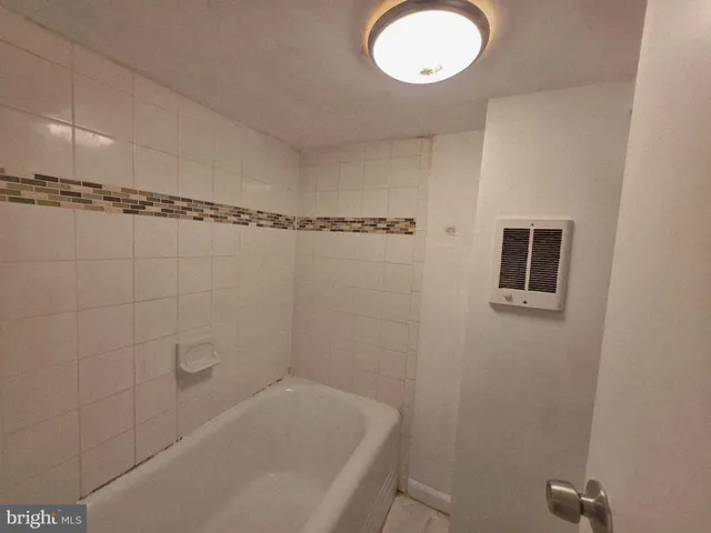 a bathroom with a window and a shower