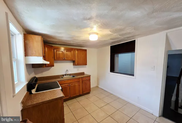 a kitchen that has a sink and a stove in it