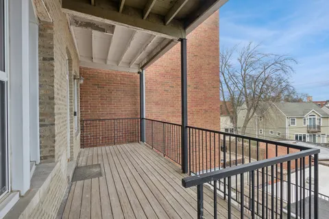 a view of balcony with wooden floor