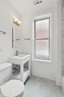a bathroom with a sink a toilet and mirror