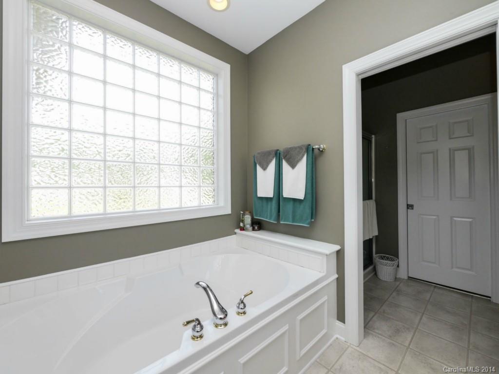450 Old Carriage Road Clover, SC 29710 - Photo 9 of 23 a bath tub sitting in a bathroom next to a window