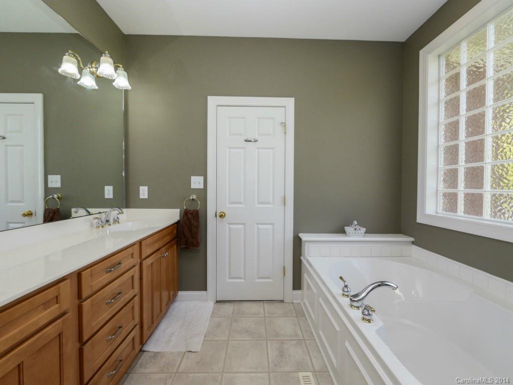 450 Old Carriage Road Clover, SC 29710 - Photo 10 of 23 a spacious bathroom with a tub double sink and mirror