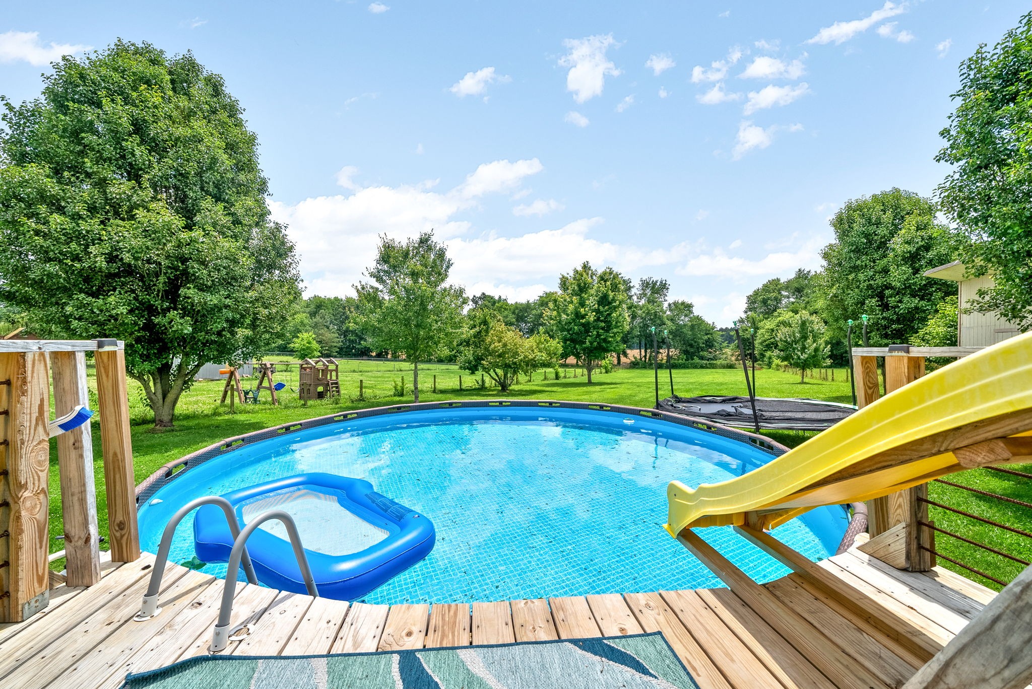 10383 Bell Station Road Oak Grove, KY 42262 - Photo 1 of 33 a view of a swimming pool with a chair and tables
