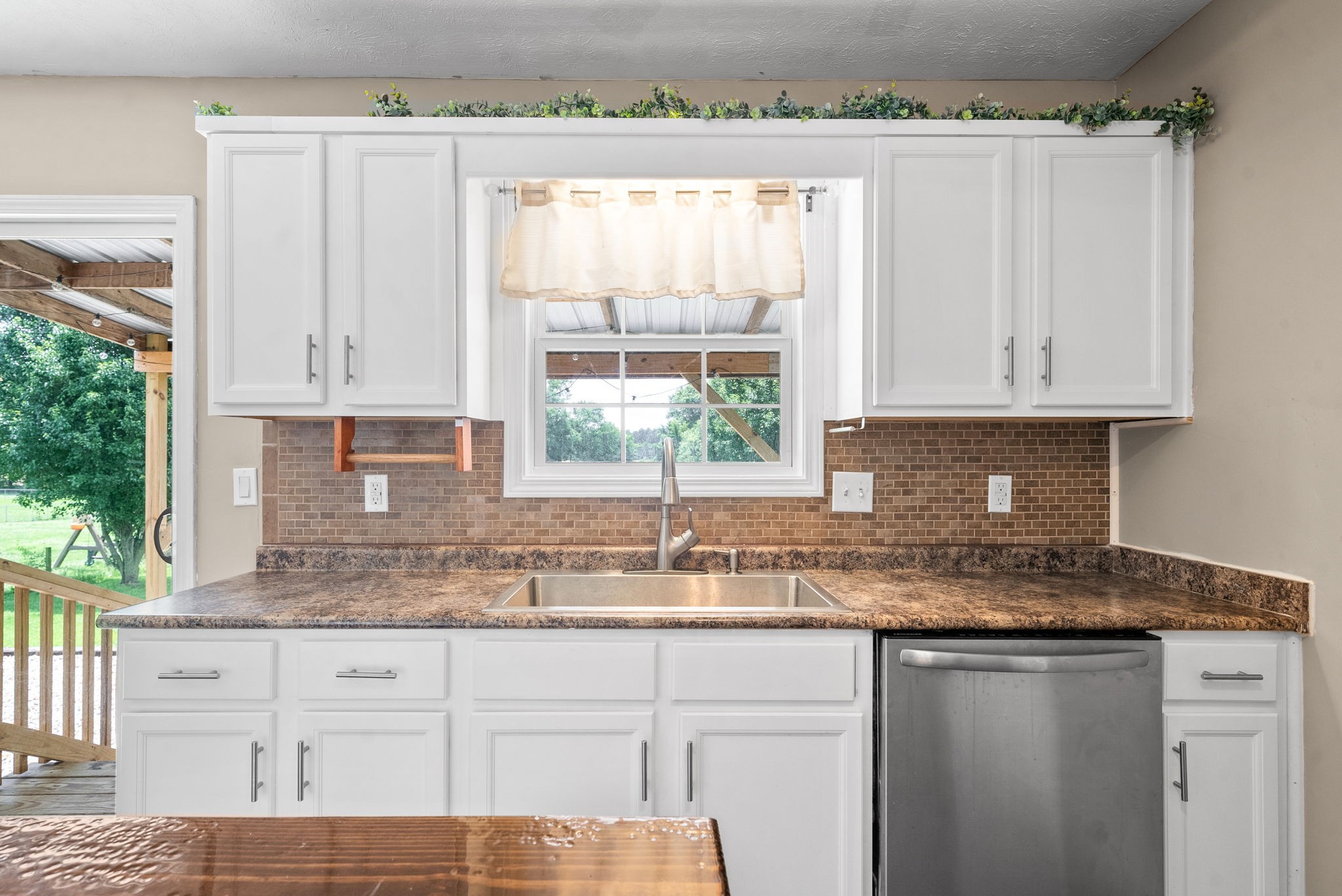 10383 Bell Station Road Oak Grove, KY 42262 - Photo 11 of 33 a kitchen with granite countertop white cabinets and a window