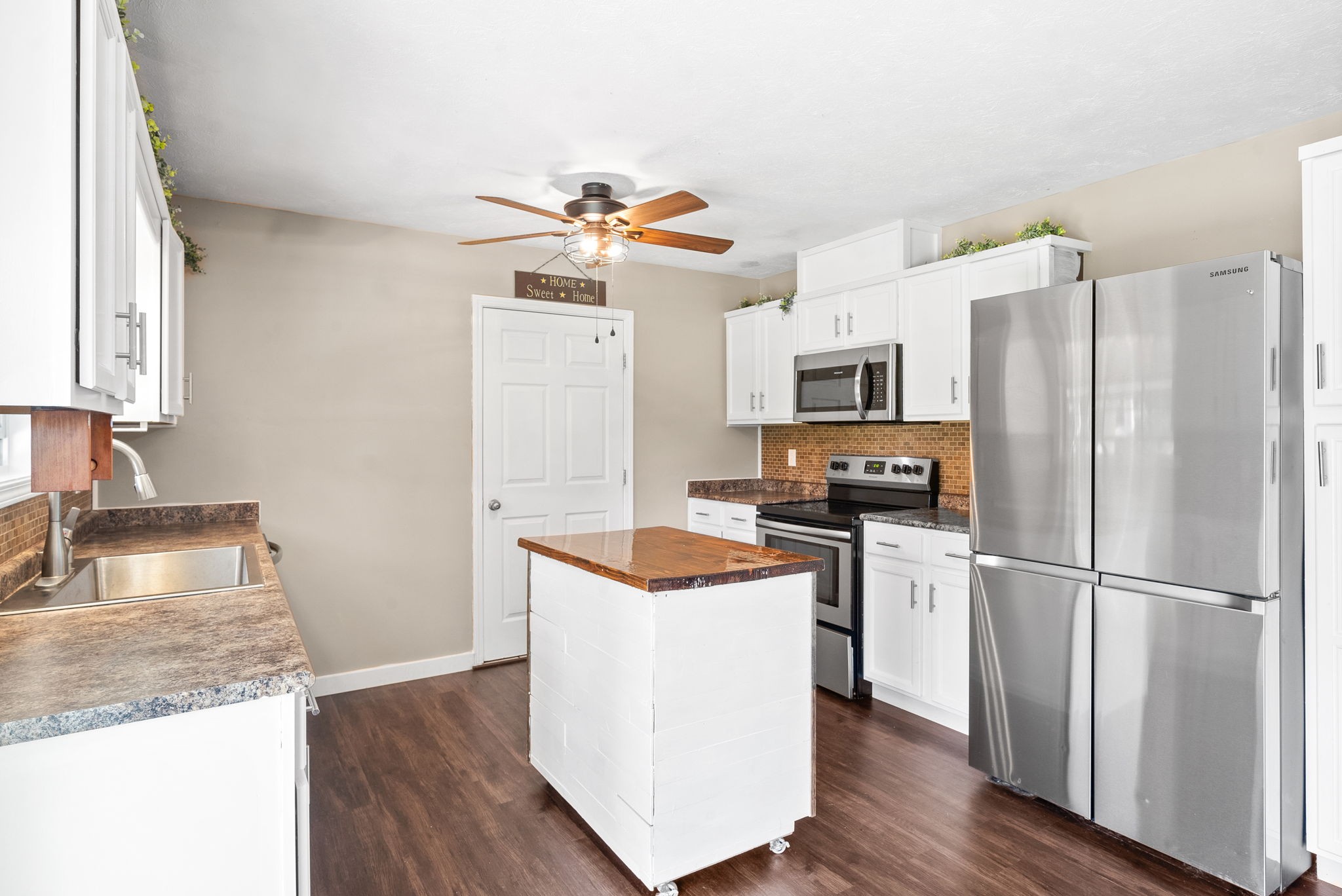 10383 Bell Station Road Oak Grove, KY 42262 - Photo 12 of 33 a kitchen with stainless steel appliances granite countertop a refrigerator a stove top oven a sink and dishwasher