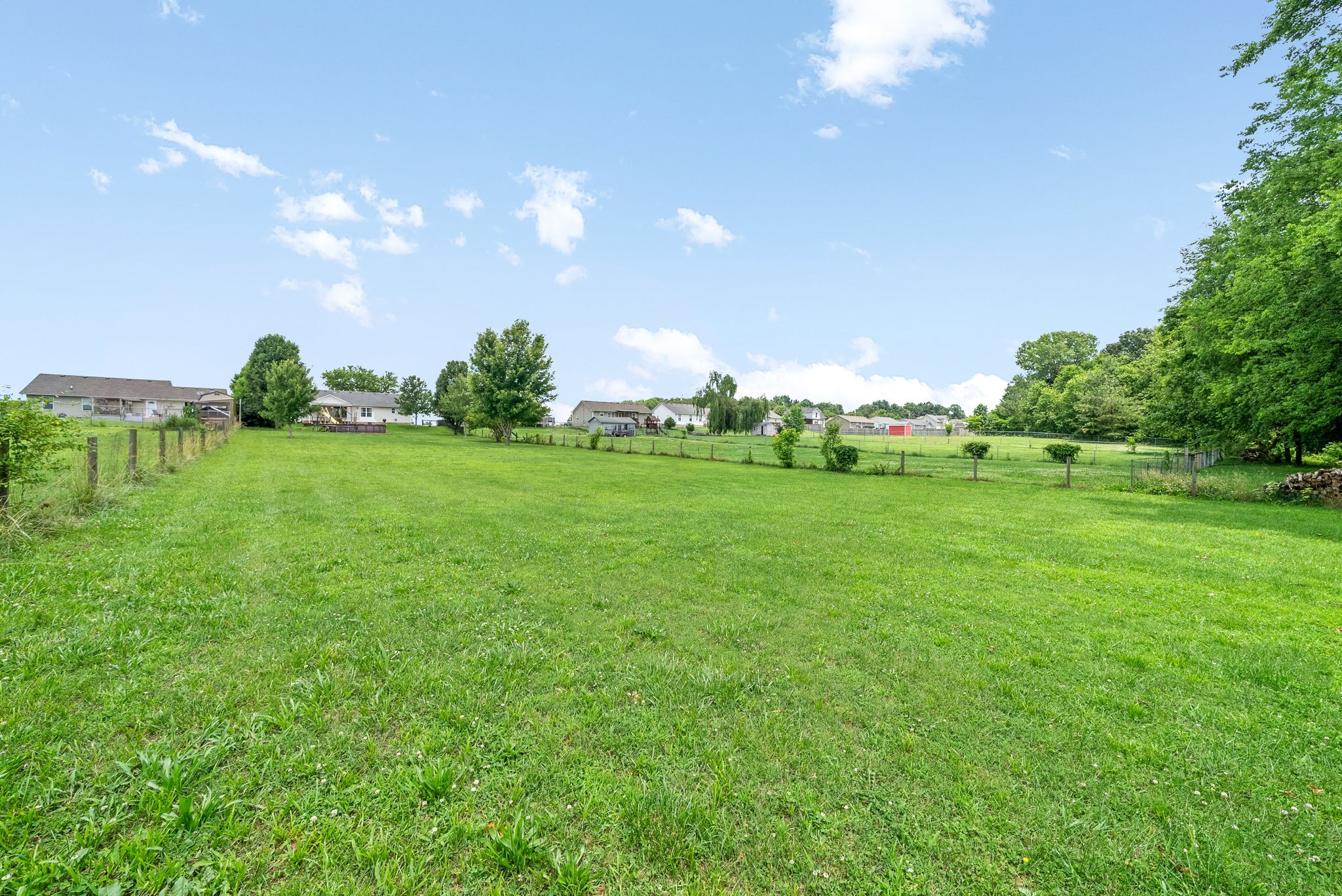 10383 Bell Station Road Oak Grove, KY 42262 - Photo 30 of 33 a yard with lots of green space and trees in the background