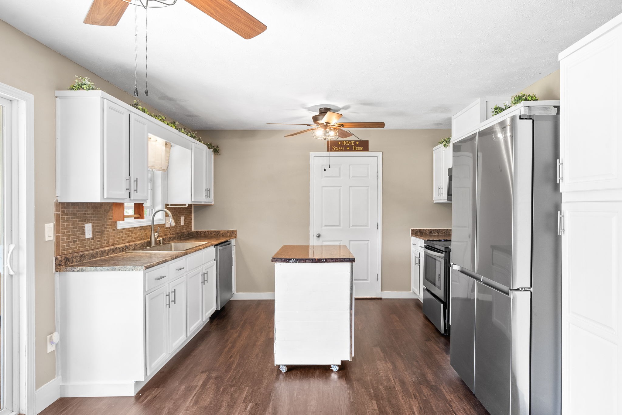 10383 Bell Station Road Oak Grove, KY 42262 - Photo 10 of 33 a kitchen with a refrigerator a sink and wooden floor