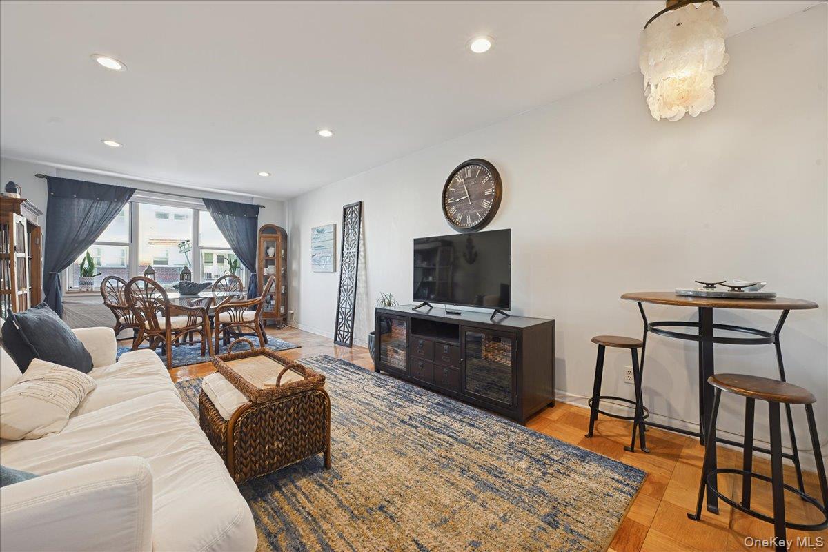 700 Shore Road, Unit 4O Long Beach, NY 11561 - Photo 7 of 42 a living room with furniture a flat screen tv and kitchen view