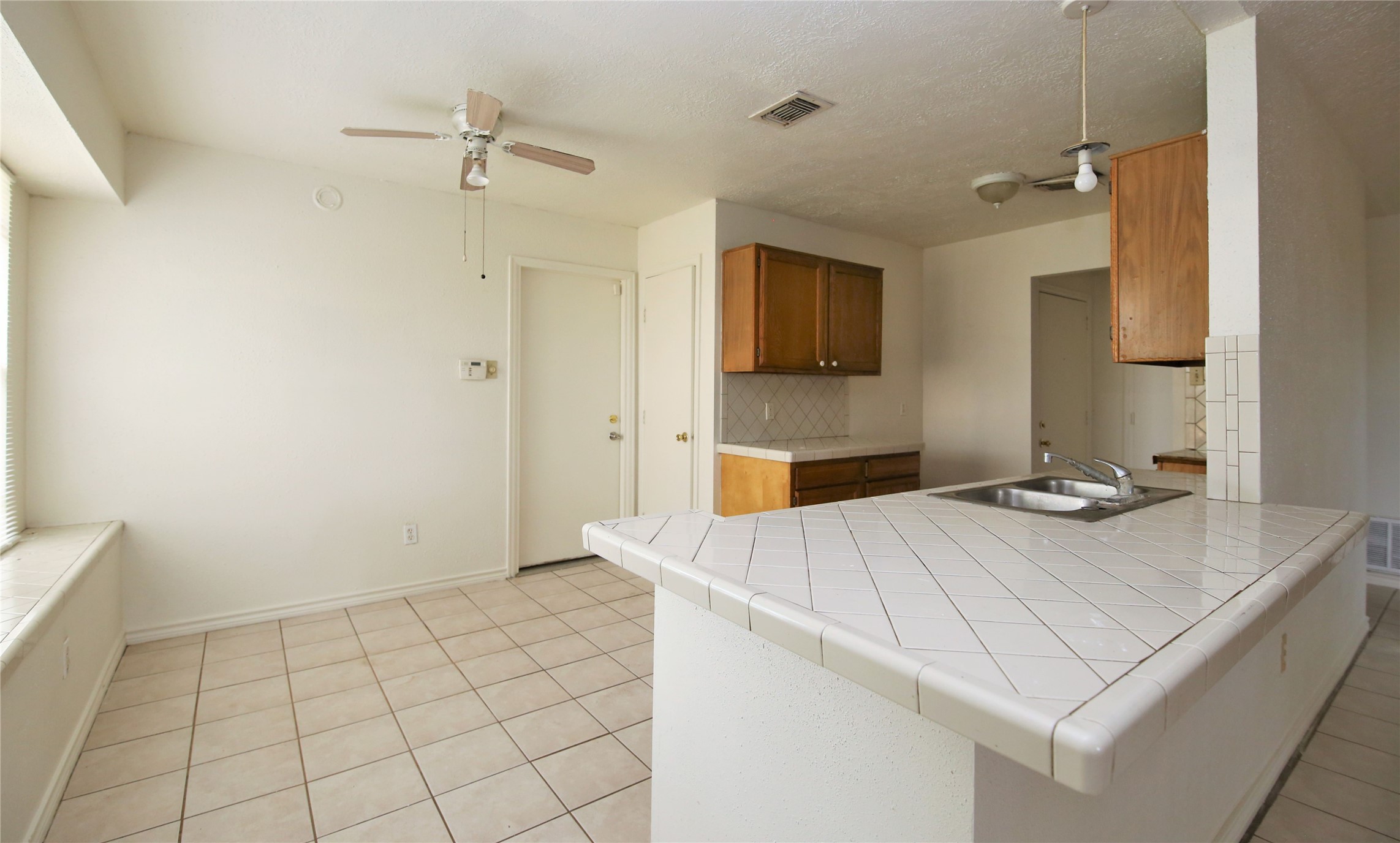 14211 Timberhaven Drive Houston, TX 77066 - Photo 6 of 19 a kitchen that has a sink and a stove in it