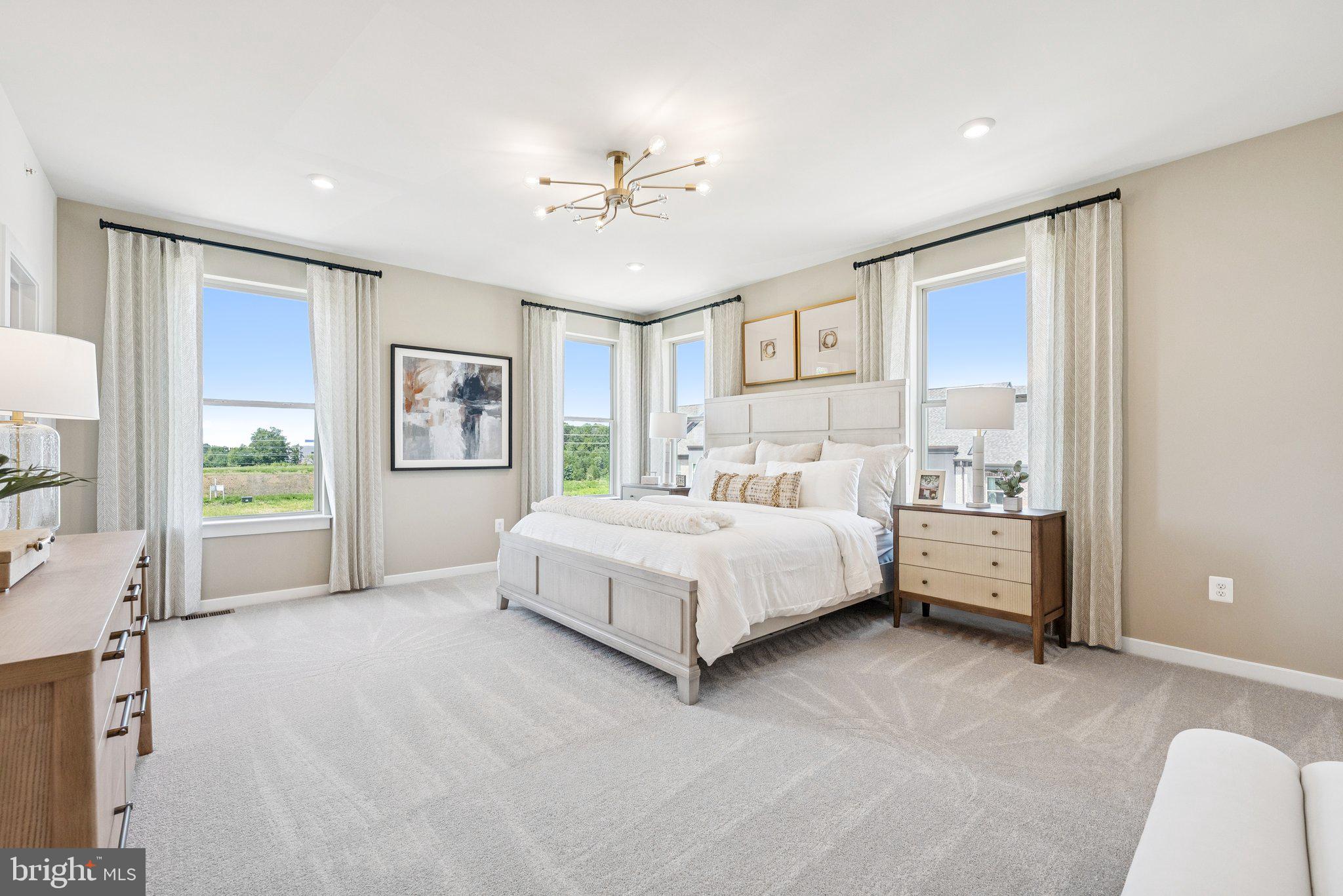 13713 Cobble Loop Woodbridge, VA 22193 - Photo 13 of 27 a spacious bedroom with a large bed and a chandelier