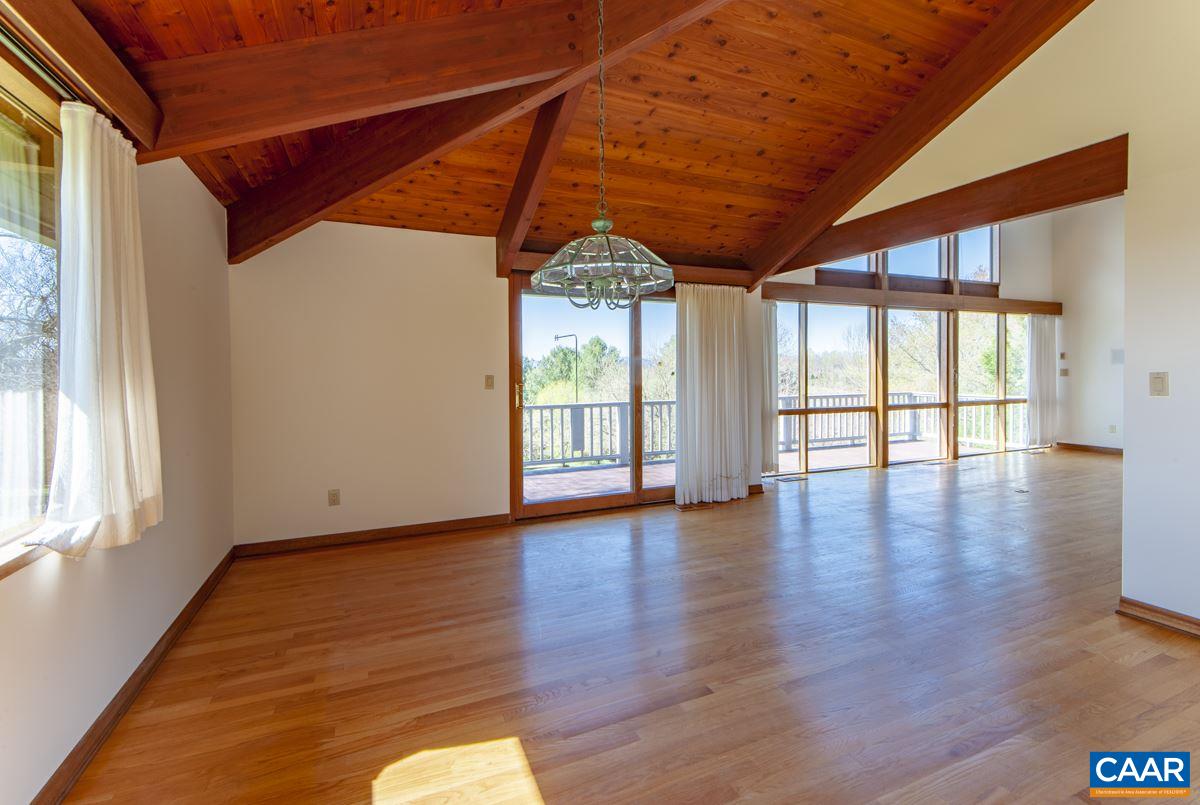 2900 Riggory Ridge Road Charlottesville, VA 22911 - Photo 16 of 44 a view of an empty room with wooden floor and a window