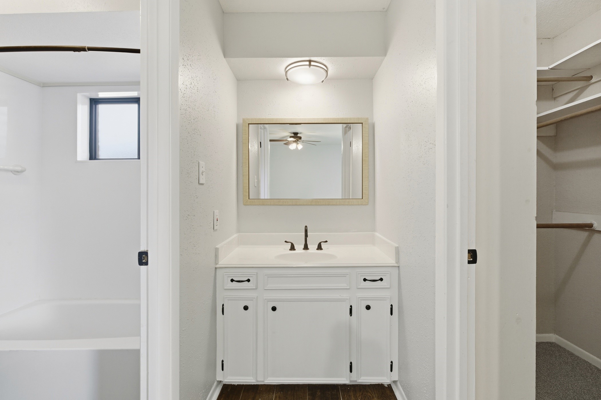 3721 Avenue R Rosenberg, TX 77471 - Photo 29 of 43 Primary ensuite vanity area with framed mirror, updated lighting, and cabinet storage.