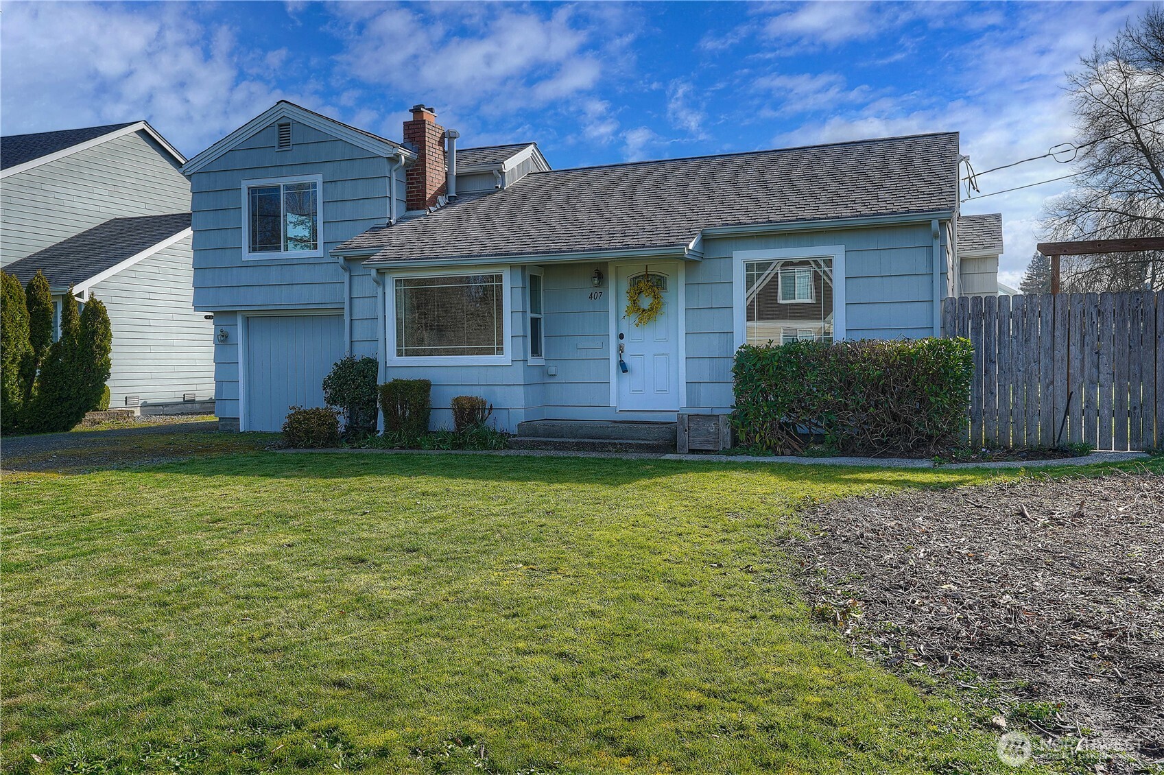 407 18th Street Southwest Puyallup, WA 98371 - Photo 1 of 40 a front view of a house with a yard