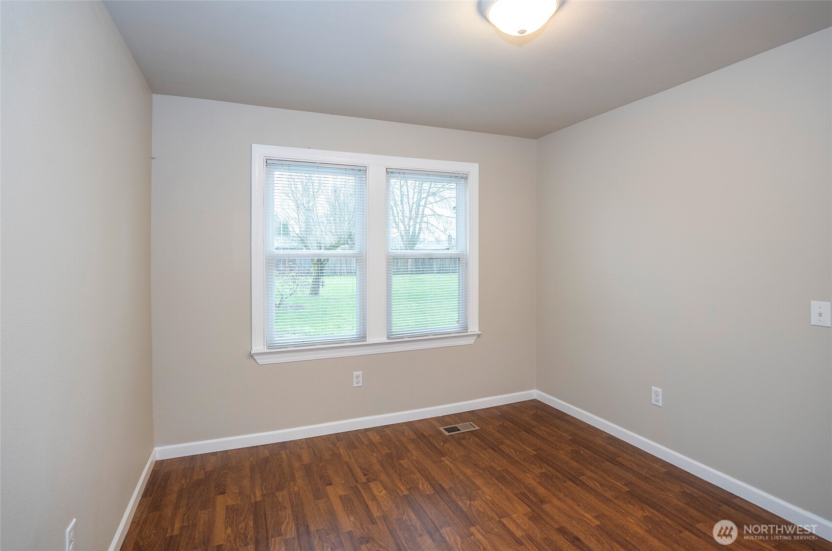 407 18th Street Southwest Puyallup, WA 98371 - Photo 16 of 40 an empty room with wooden floor and windows