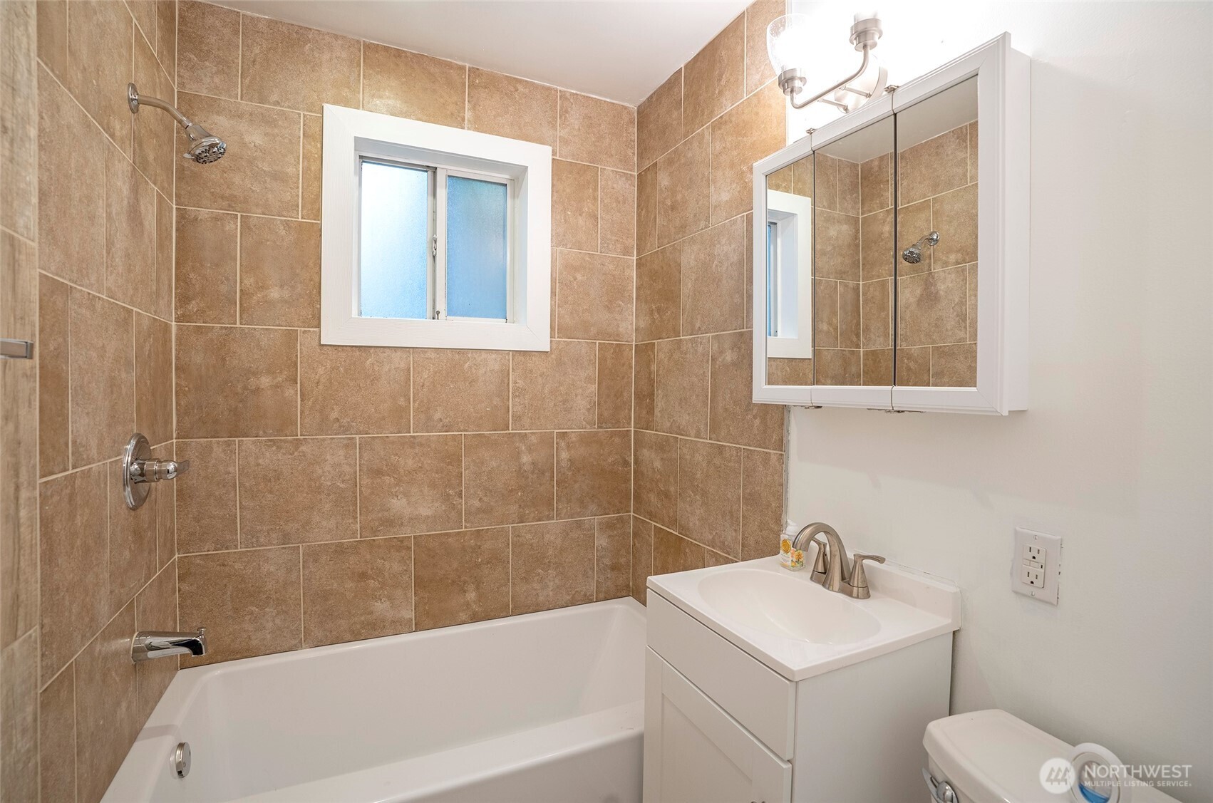 407 18th Street Southwest Puyallup, WA 98371 - Photo 18 of 40 a bathroom with a sink a toilet and shower