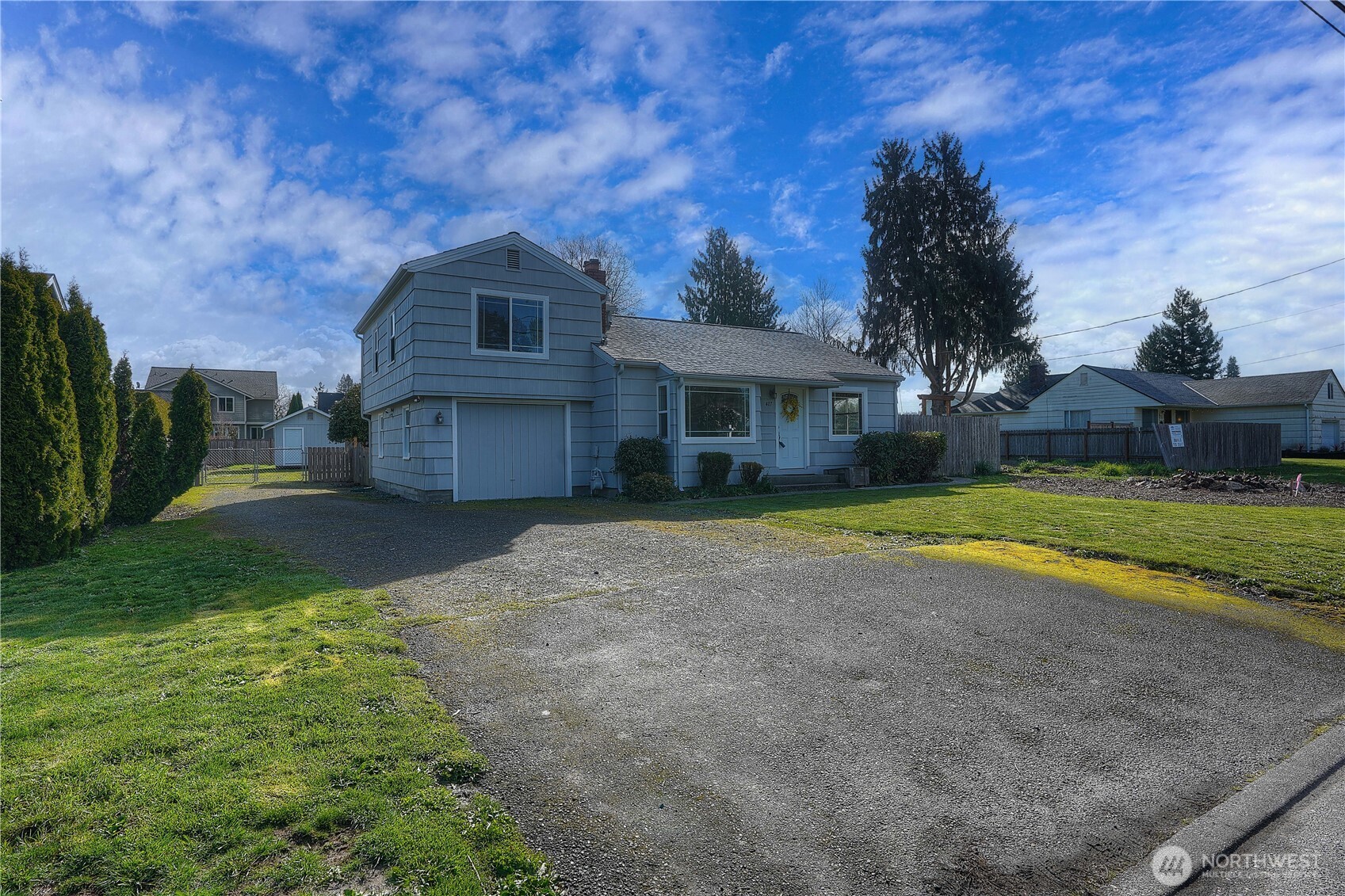 407 18th Street Southwest Puyallup, WA 98371 - Photo 2 of 40 a front view of a house with a yard and garage