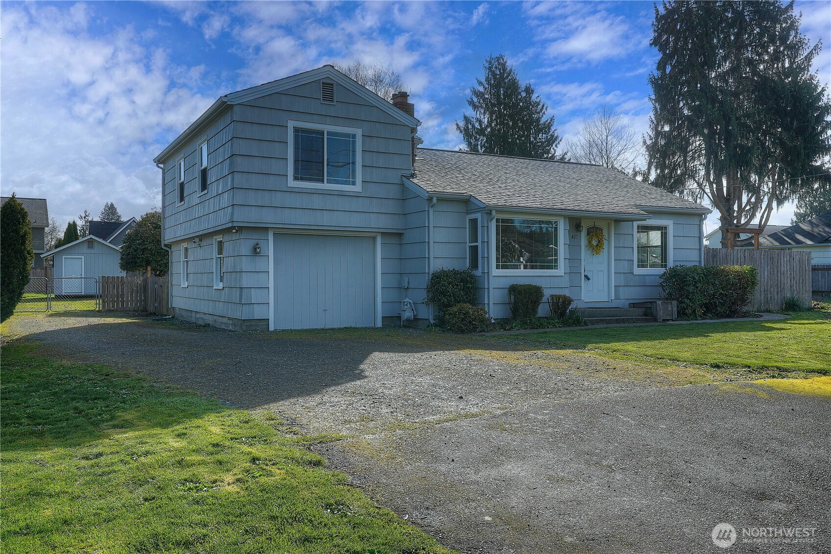 407 18th Street Southwest Puyallup, WA 98371 - Photo 28 of 40 a front view of a house with a yard and garage