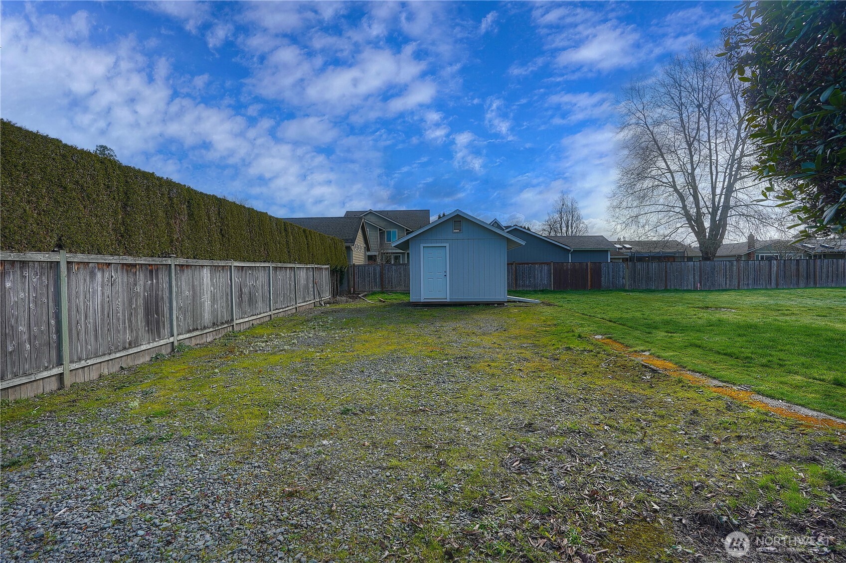 407 18th Street Southwest Puyallup, WA 98371 - Photo 37 of 40 a view of a backyard with a small cabin and wooden fence