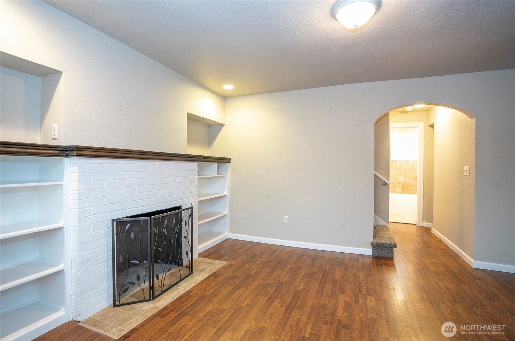 407 18th Street Southwest Puyallup, WA 98371 - Photo 5 of 40 a view of empty room with wooden floor and fireplace