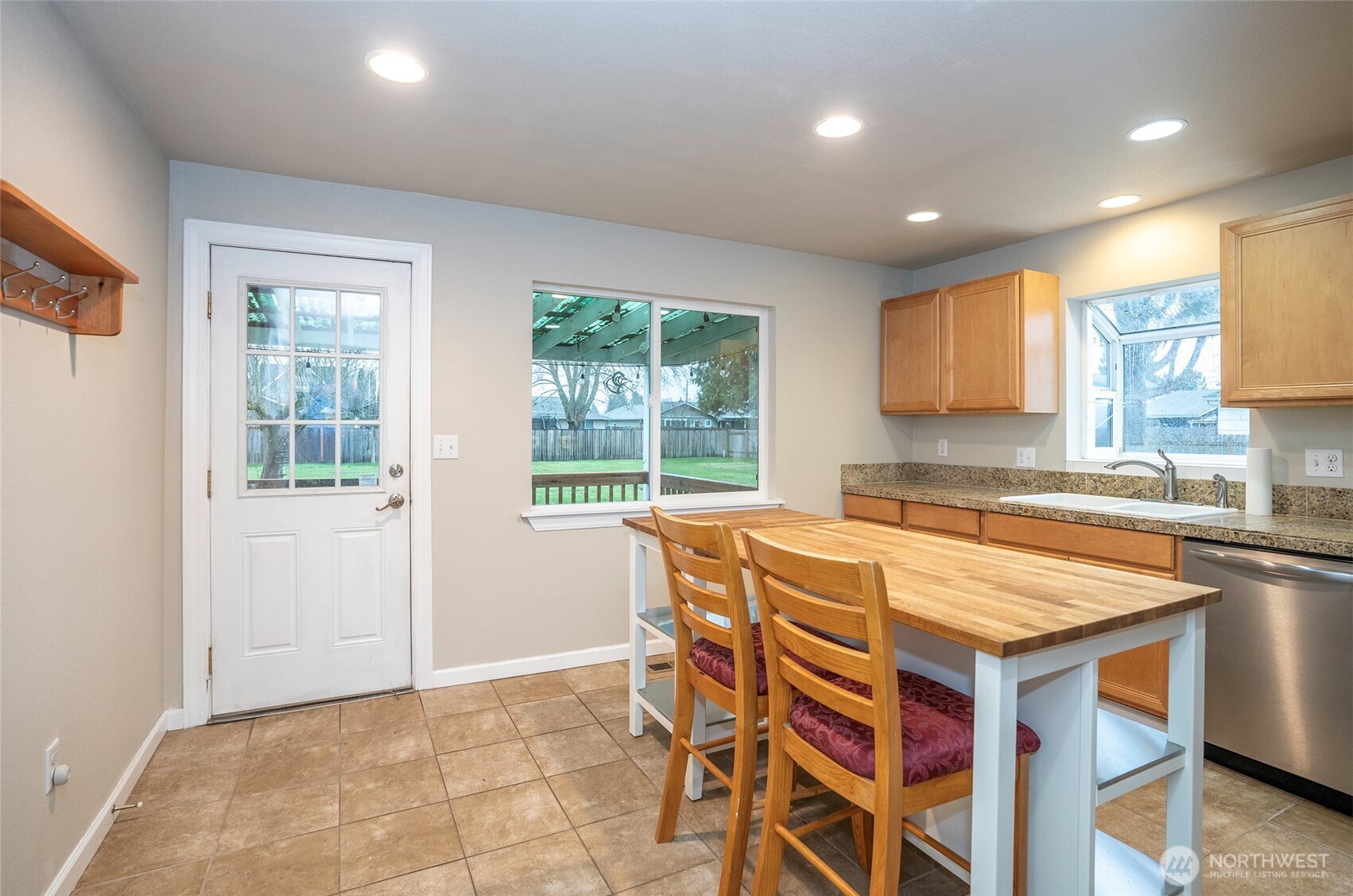 407 18th Street Southwest Puyallup, WA 98371 - Photo 9 of 40 a kitchen that has a sink and a table in it with wooden floor