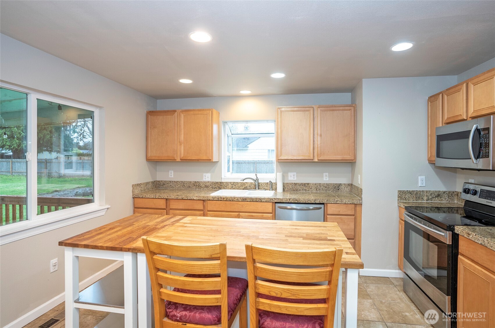 407 18th Street Southwest Puyallup, WA 98371 - Photo 10 of 40 a kitchen with a stove a sink and a refrigerator