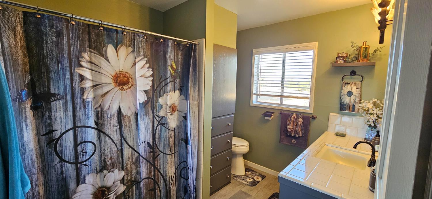 20822 Disch Road Lockeford, CA 95237 - Photo 13 of 30 a bathroom with a bathtub and shower