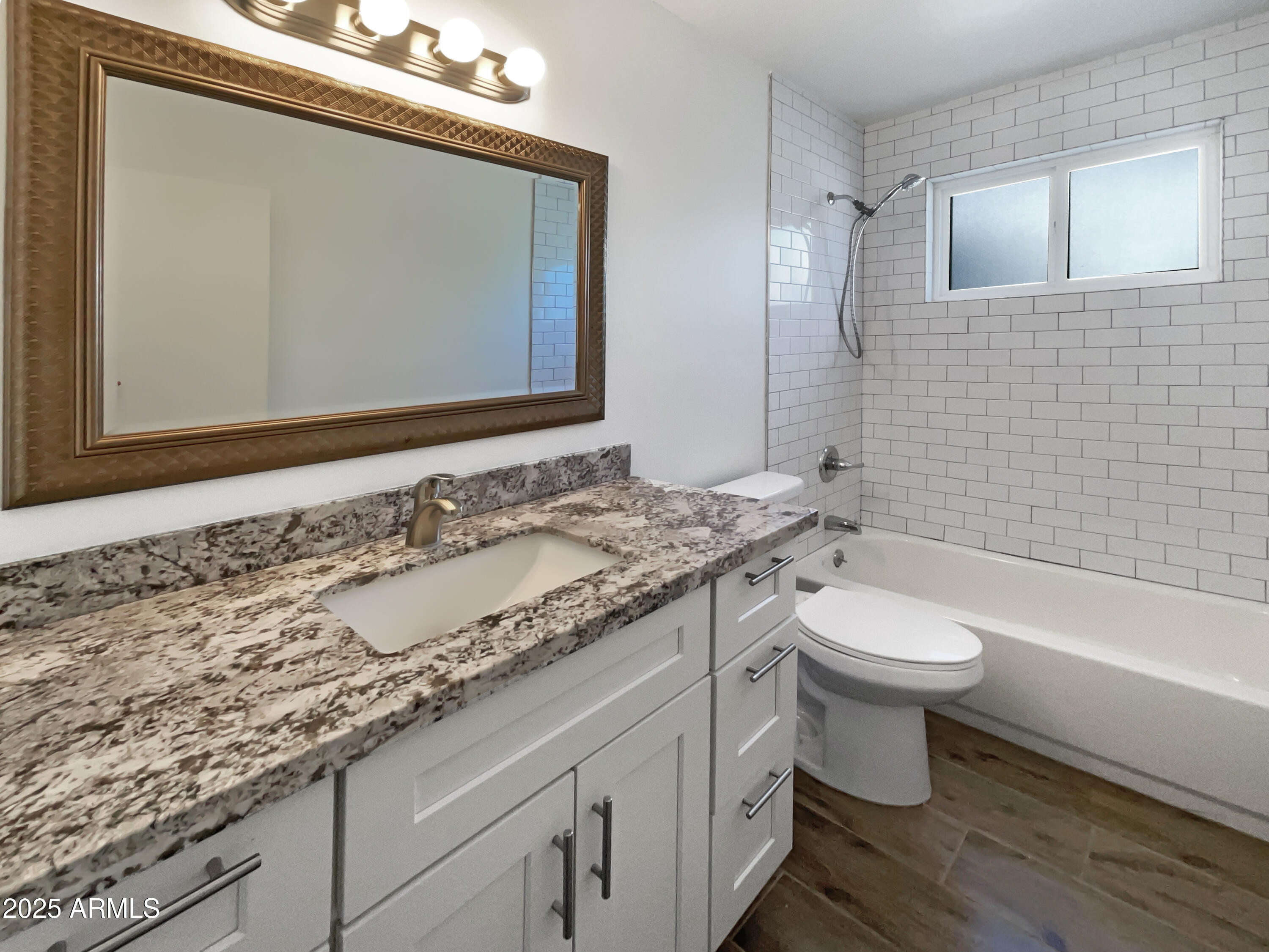 7231 North 23rd Avenue Phoenix, AZ 85021 - Photo 15 of 28 a bathroom with a granite countertop toilet sink and mirror