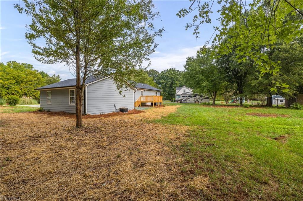 7211 Mason Road Climax, NC 27233 - Photo 22 of 31 A view of the back yard and the back of the garage.
