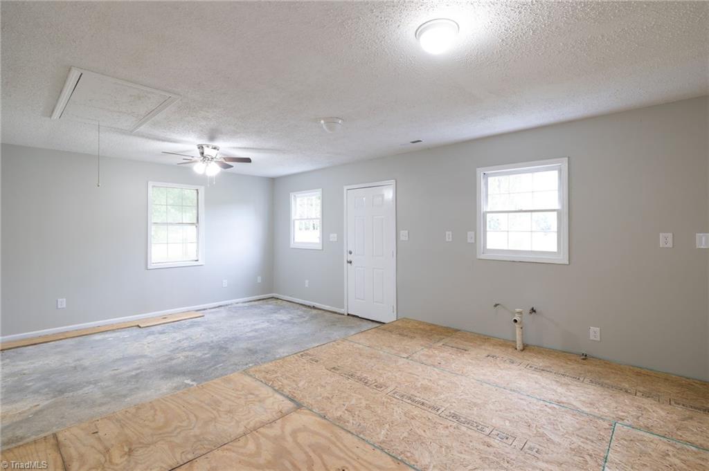 7211 Mason Road Climax, NC 27233 - Photo 28 of 31 A view from the raised platform from the eating and kitchen area towards the living area. This would make a great office or a very nice garage.