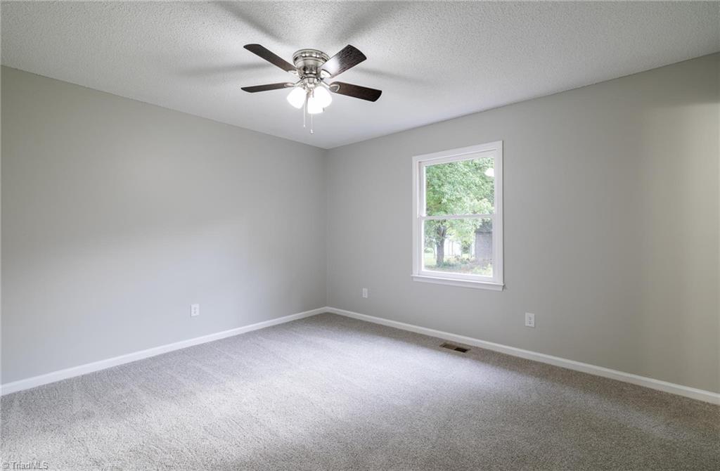 7211 Mason Road Climax, NC 27233 - Photo 10 of 31 Primary bedroom with ceiling fan.