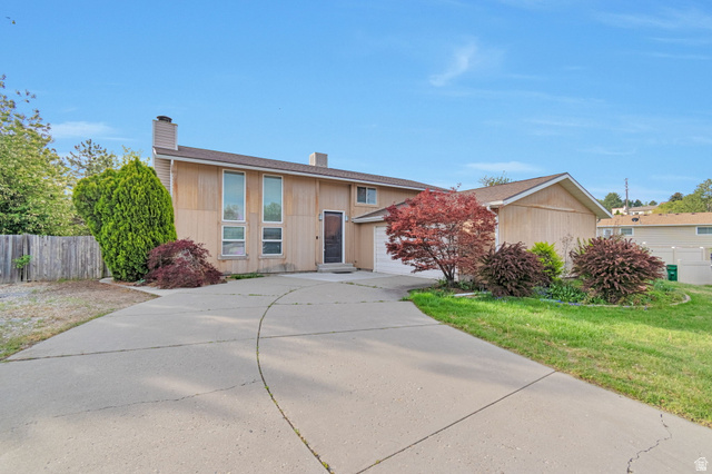1764 Rondelle Circle Sandy, UT 84093 - Photo 1 of 1 View of front of home with a chimney, a garage, and concrete driveway