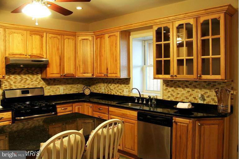 1213 West Old Cold Spring Lane Baltimore, MD 21211 - Photo 2 of 15 a kitchen with a sink and cabinets