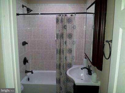1213 West Old Cold Spring Lane Baltimore, MD 21211 - Photo 11 of 15 a bathroom with a sink and shower