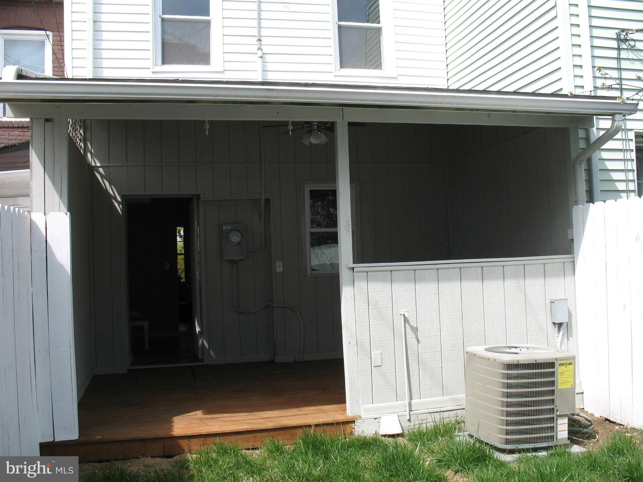 1213 West Old Cold Spring Lane Baltimore, MD 21211 - Photo 14 of 15 a front view of a house with a yard