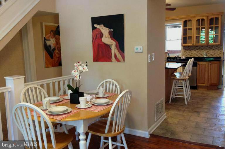 1213 West Old Cold Spring Lane Baltimore, MD 21211 - Photo 5 of 15 a view of a dining room with furniture and wooden floor