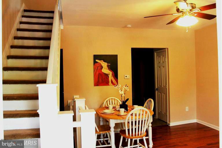 1213 West Old Cold Spring Lane Baltimore, MD 21211 - Photo 6 of 15 a view of a dining room with furniture and wooden floor
