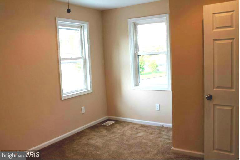 1213 West Old Cold Spring Lane Baltimore, MD 21211 - Photo 9 of 15 an empty room with windows